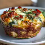 Fluffy egg muffins loaded with ham, veggies, and melted cheddar cheese for a protein-rich breakfast.  