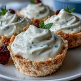 Bright and tangy lemon mousse in elegant glasses, garnished with mint and paired with crisp shortbread cookies.  