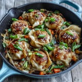 Savory Hot Honey Cabbage Dumpling Skillet, ready to be enjoyed with garnishes.