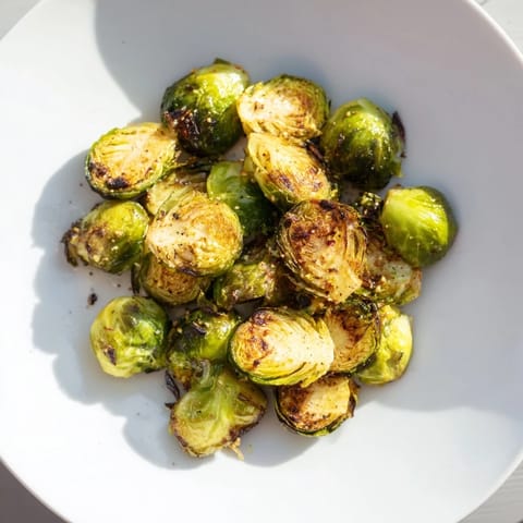 Caramelized roasted Brussels sprouts with a simple olive oil glaze, ready to serve hot.