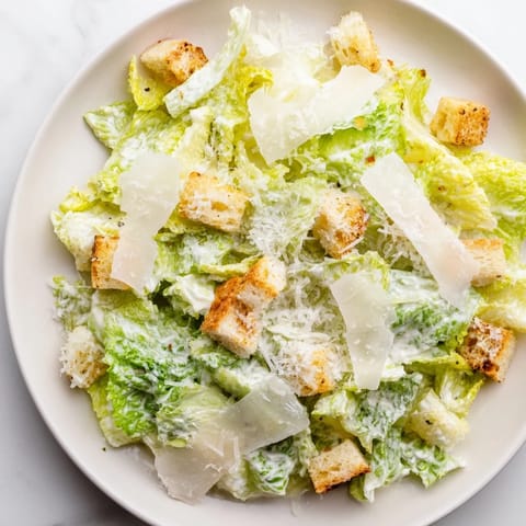 Fresh and vibrant Caesar salad, with crisp romaine, creamy dressing, Parmesan, and croutons.