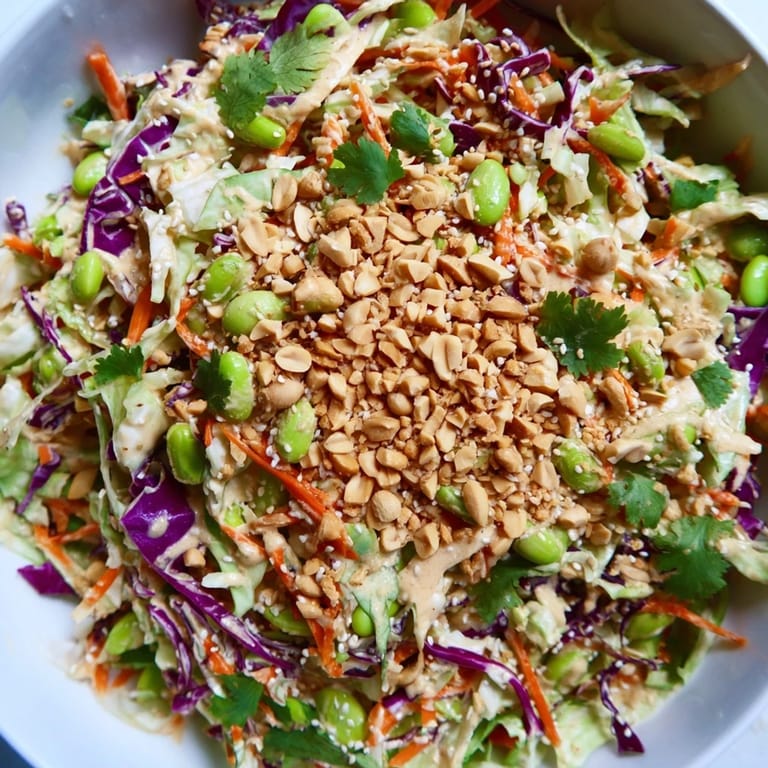 Enjoy this Crunchy Thai Peanut Salad as a light meal or side, tossed in tangy dressing with sesame seeds.