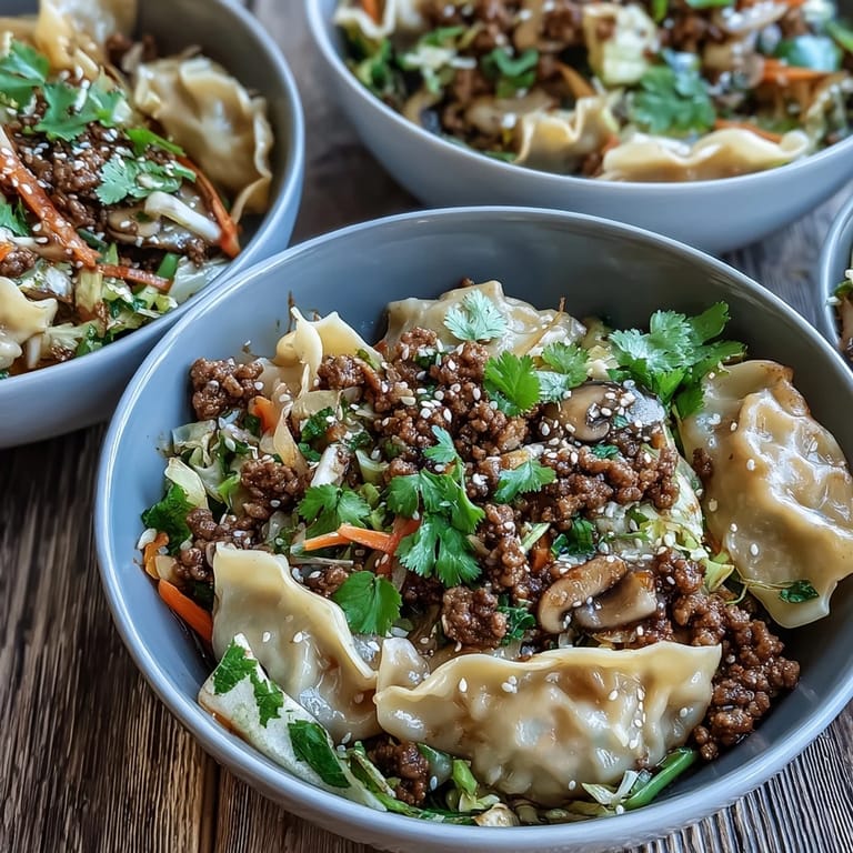 A steaming bowl of Potsticker Noodle Bowls topped with green onions and sesame seeds.
