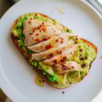 Crisp sourdough topped with creamy smashed avocado and juicy grilled chicken, finished with chili flakes and honey.