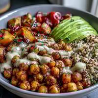 Golden roasted vegetables and spiced crispy chickpeas sit on fluffy quinoa in this vibrant Chickpea Power Bowl.